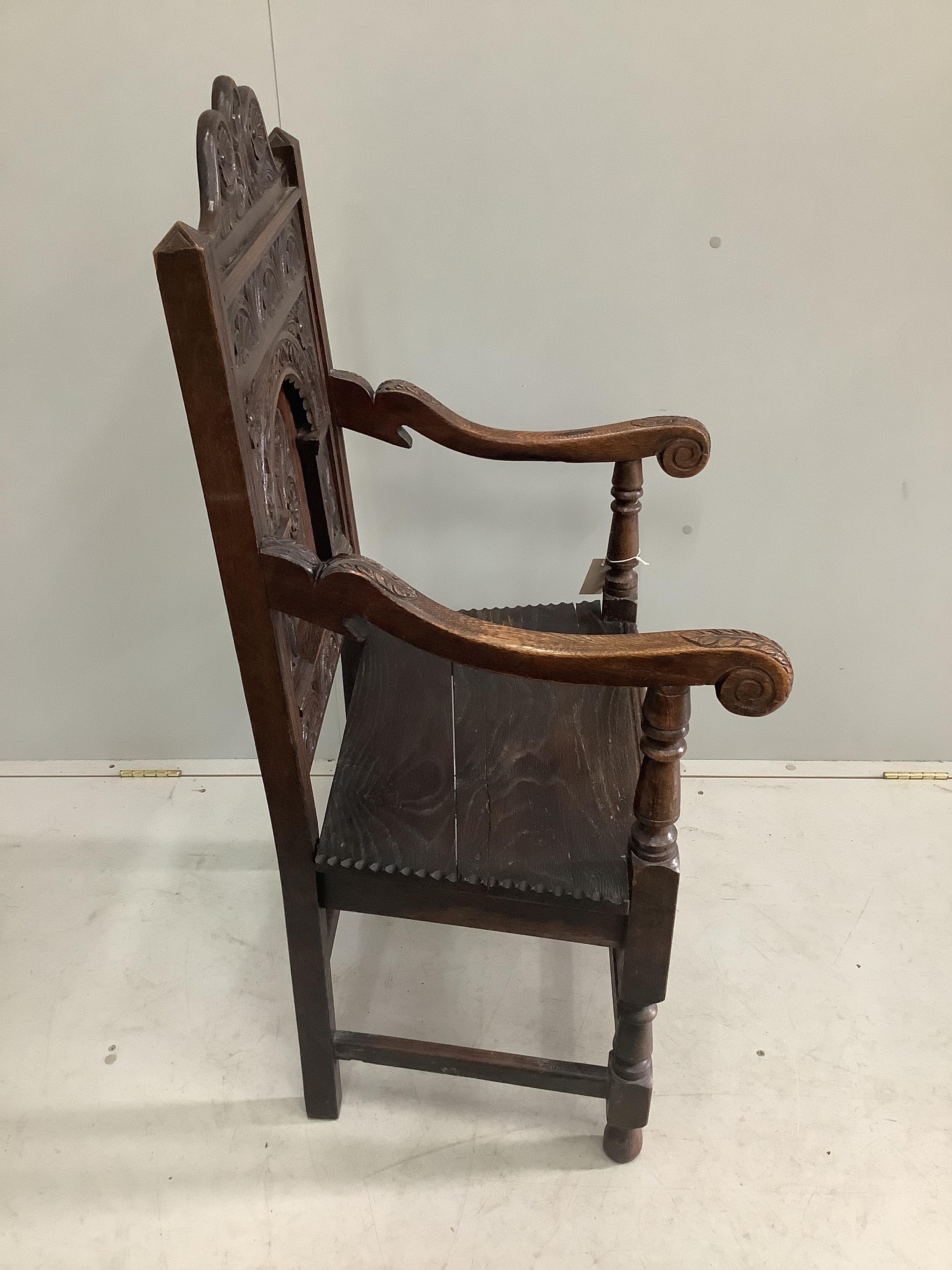 A 19th century oak panel back wainscot armchair, width 57cm, depth 54cm, height 117cm